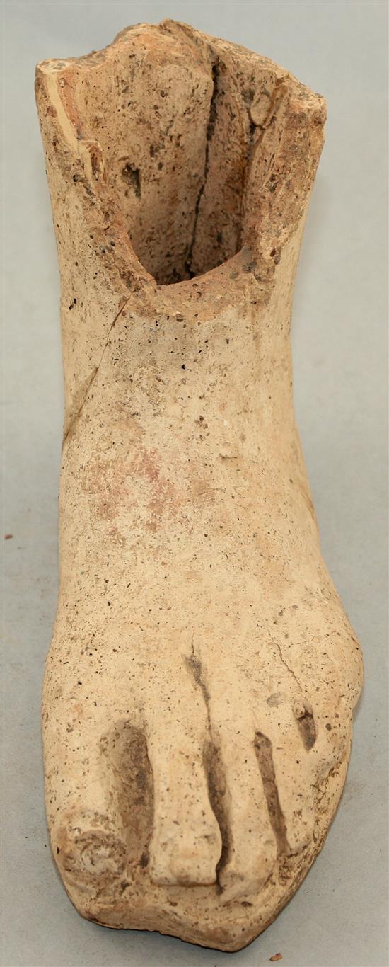 An Etruscan terracotta votive left foot, c.3rd century BC, 21cm, repaired